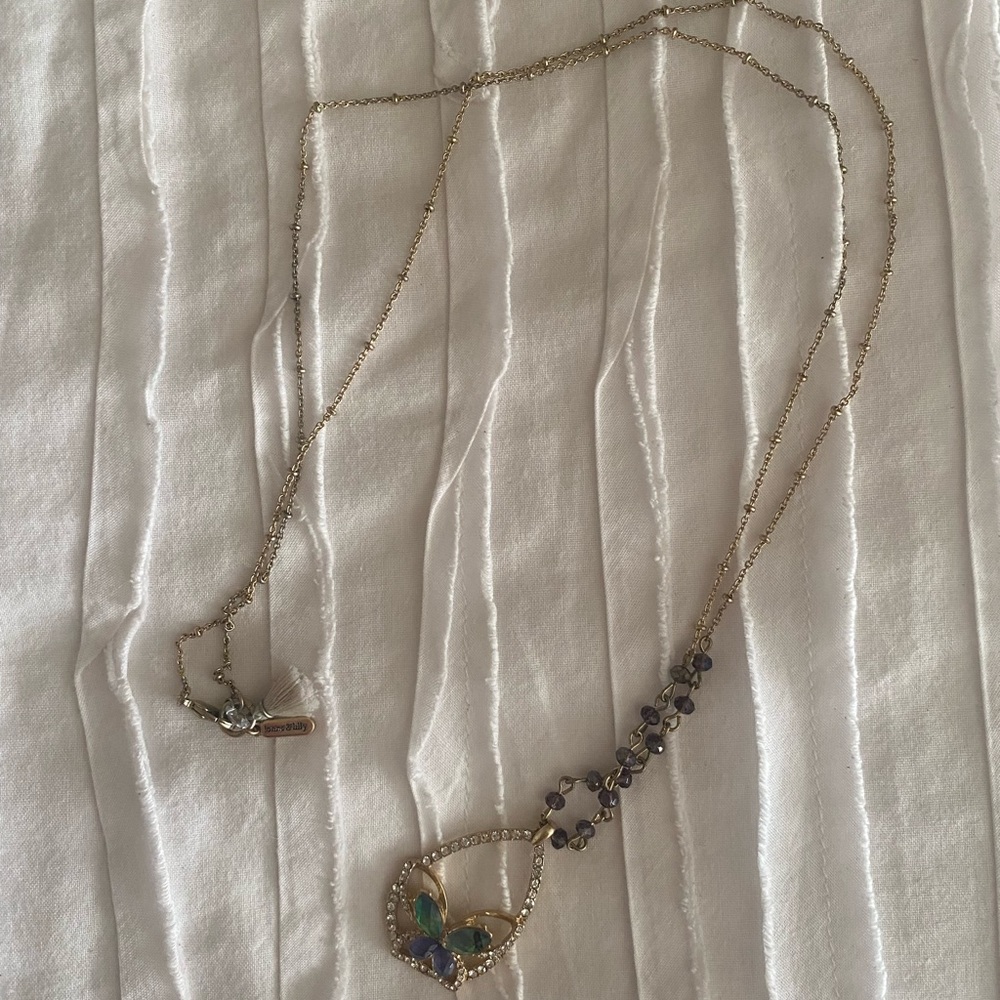 Butterfly necklace with tassel on the back.